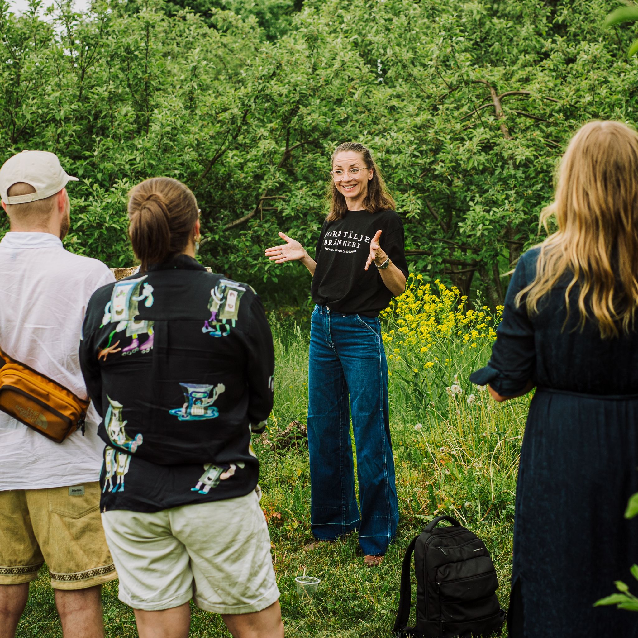 Anna står och pratar om vår verksamhet inför en grupp gäster