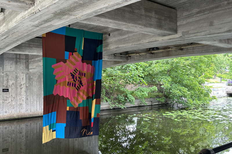 Ett konstverk i tyg h&auml;nger under en bro i Norrt&auml;lje&aring;n
